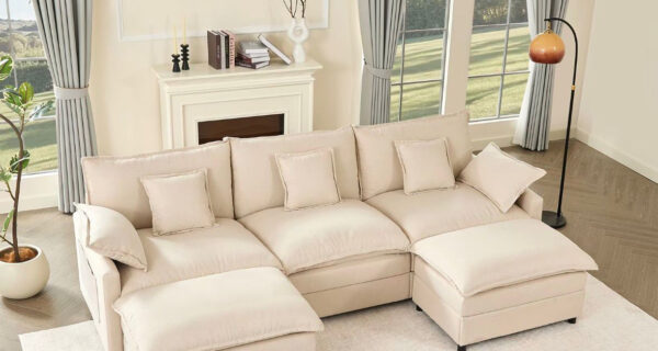 Cream linen U-shaped modular sectional sofa with two movable ottomans in a bright living room